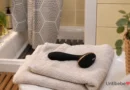 Objet de bien-être intime posé sur des serviettes dans une salle de bain
